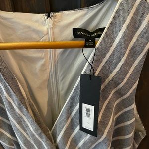 Grey sleeveless with a flattering tailored fit.